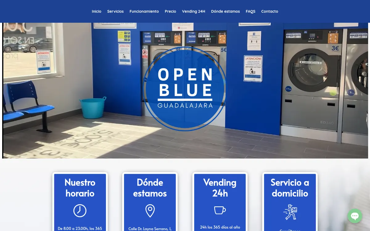 Portada de la web de Open Blue Guadalajara: el logotipo circular azul sobre una foto del local, con lavadoras industriales y paredes azules.